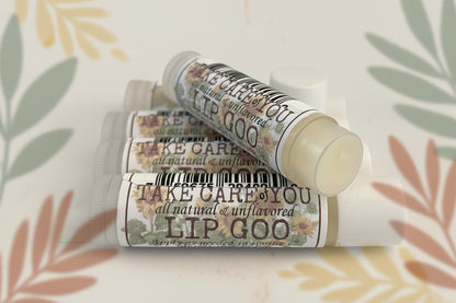 Three tubes of 'Take Care You' lip goo on a light background