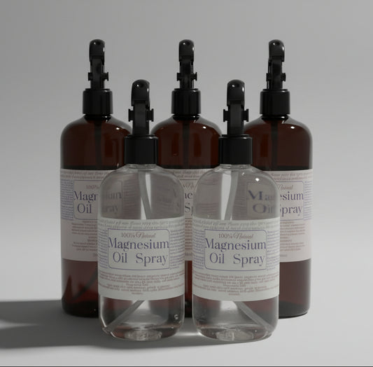 Bottles of magnesium oil spray with labels on a light surface