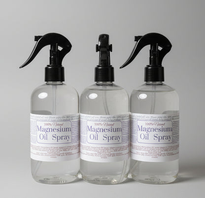 Three bottles of magnesium oil spray on a light background